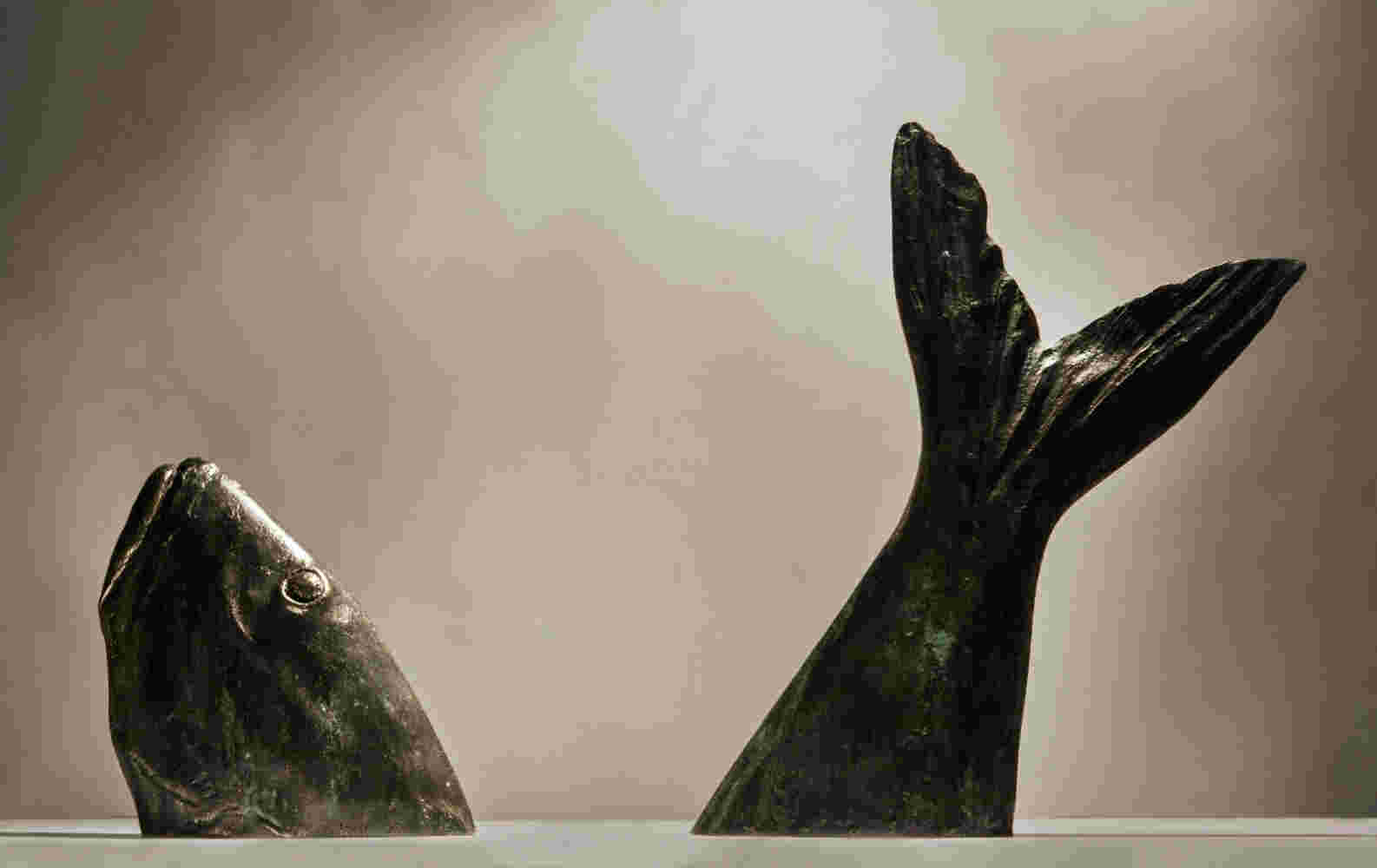 Surrealistic bronze sculpture of a diving fish