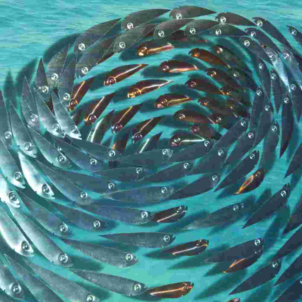 Three-dimensional wall sculpture, school of fish theme, with layers of plexiglass, aluminum frame and swirling copper fish.