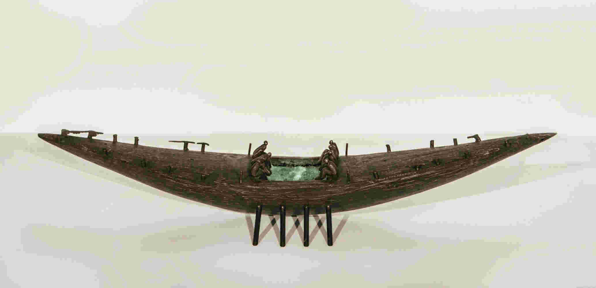 Small boat sculpture made of cast bronze.