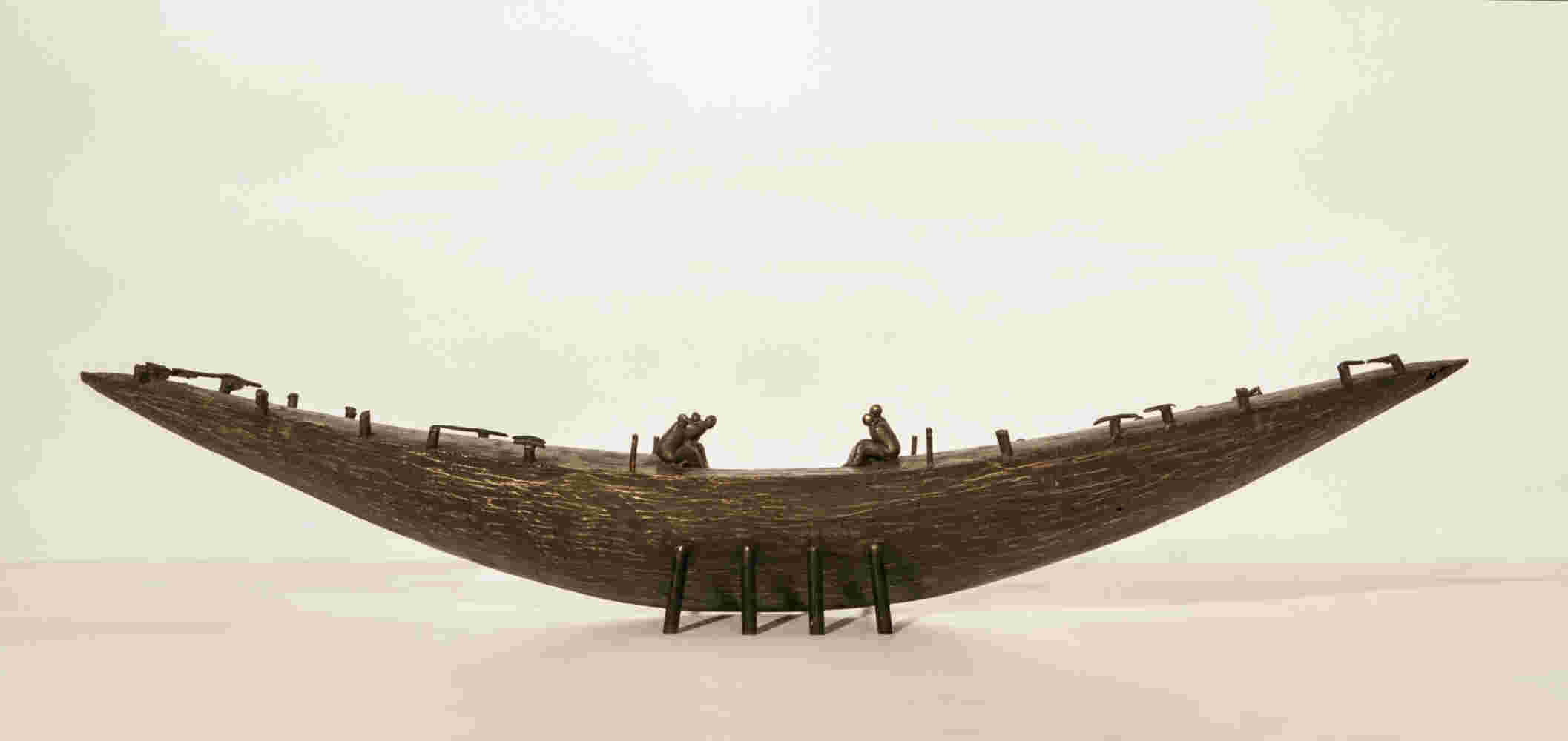 Small boat sculpture made of cast bronze.