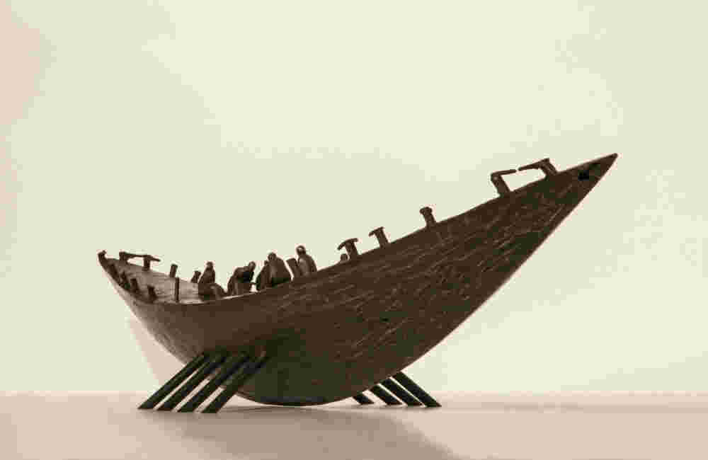 Small boat sculpture made of cast bronze.