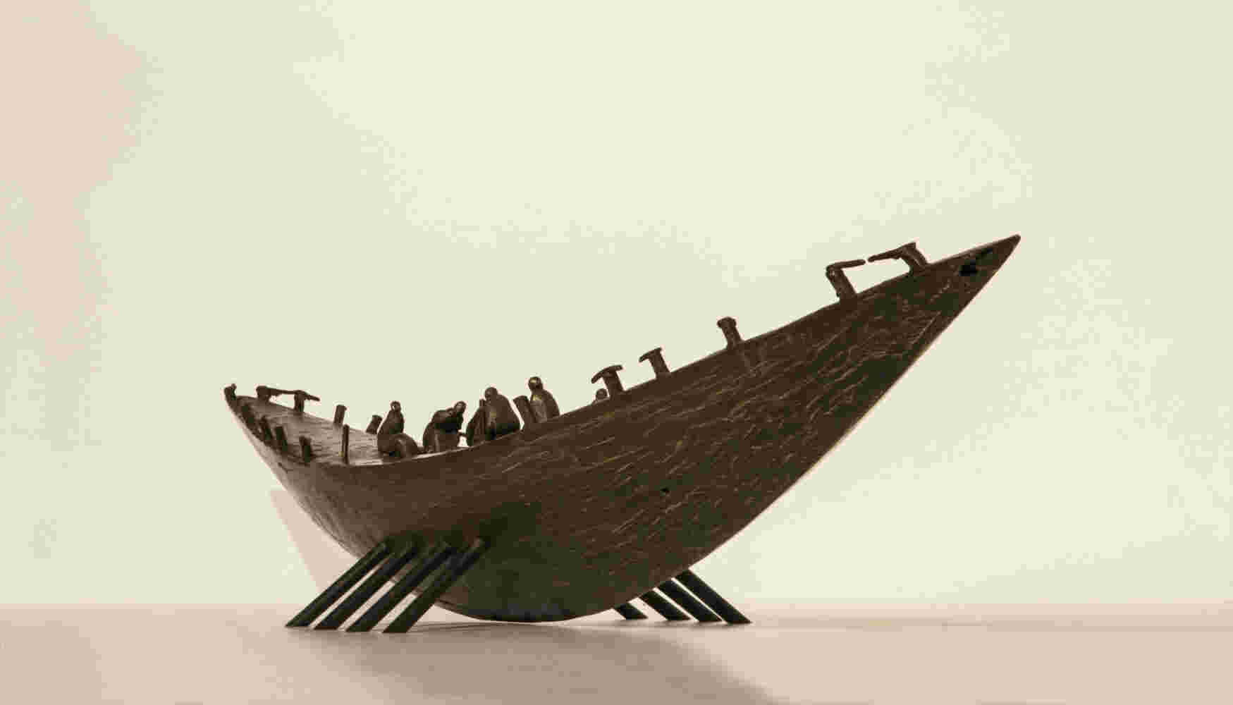 Small boat sculpture made of cast bronze.