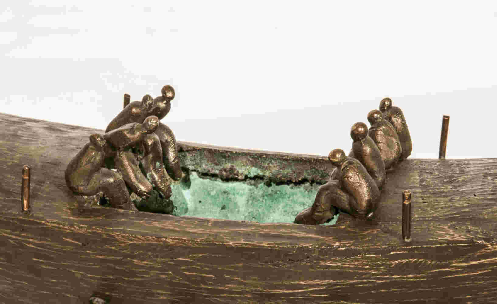Small boat sculpture made of cast bronze.