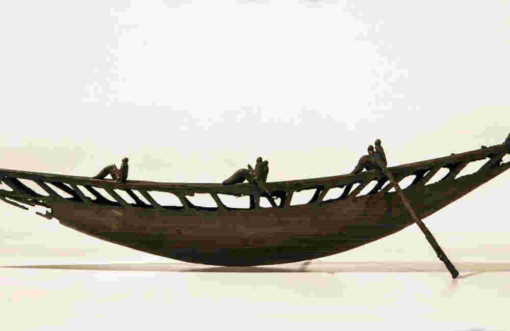 Small boat sculpture made of cast bronze.