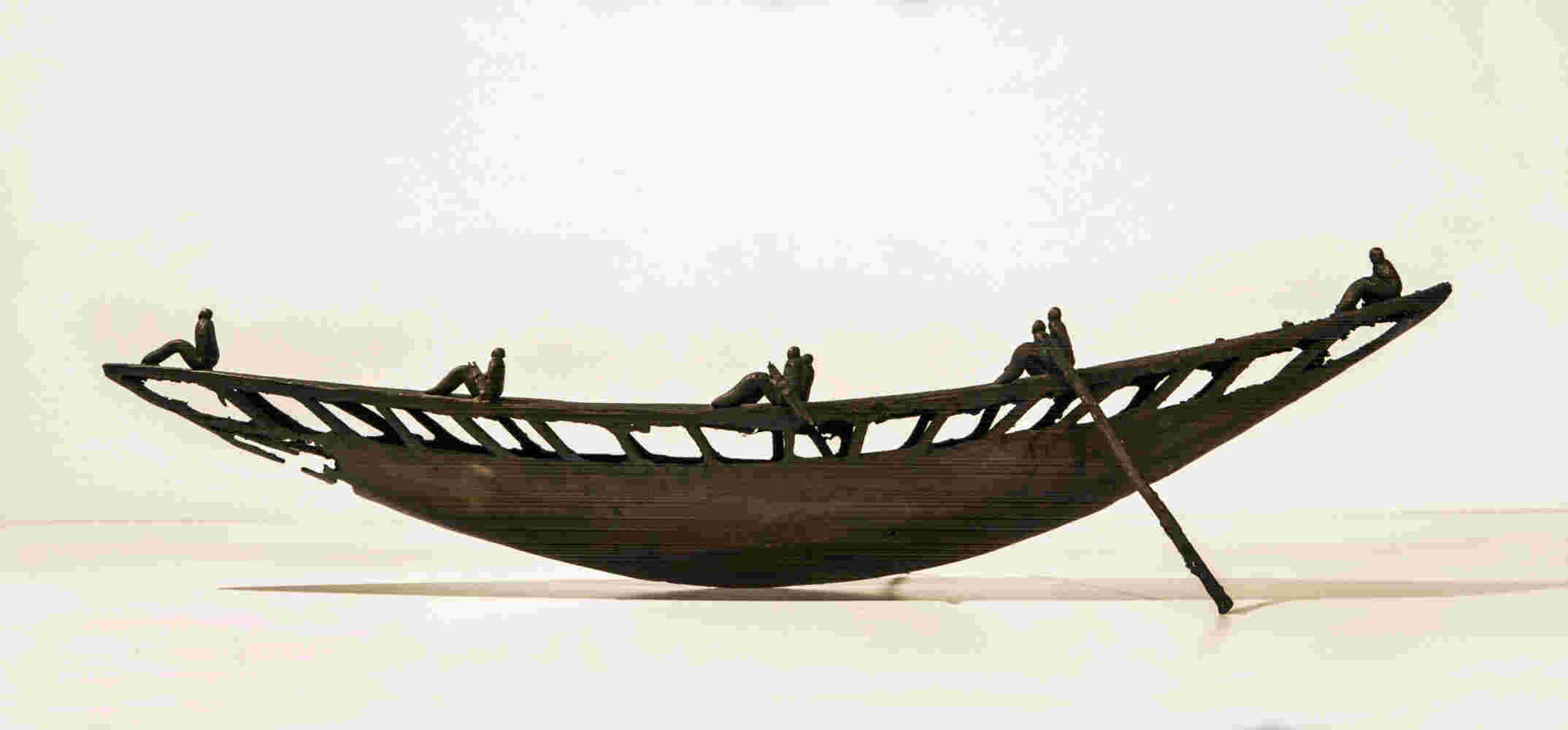 Small boat sculpture made of cast bronze.