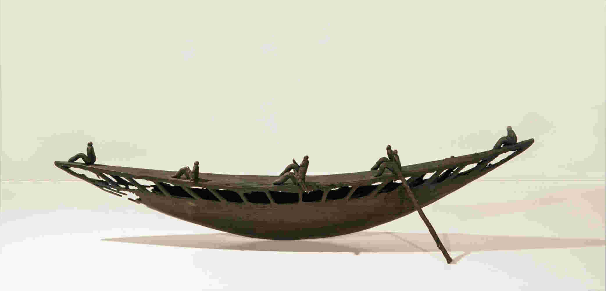 Small boat sculpture made of cast bronze.