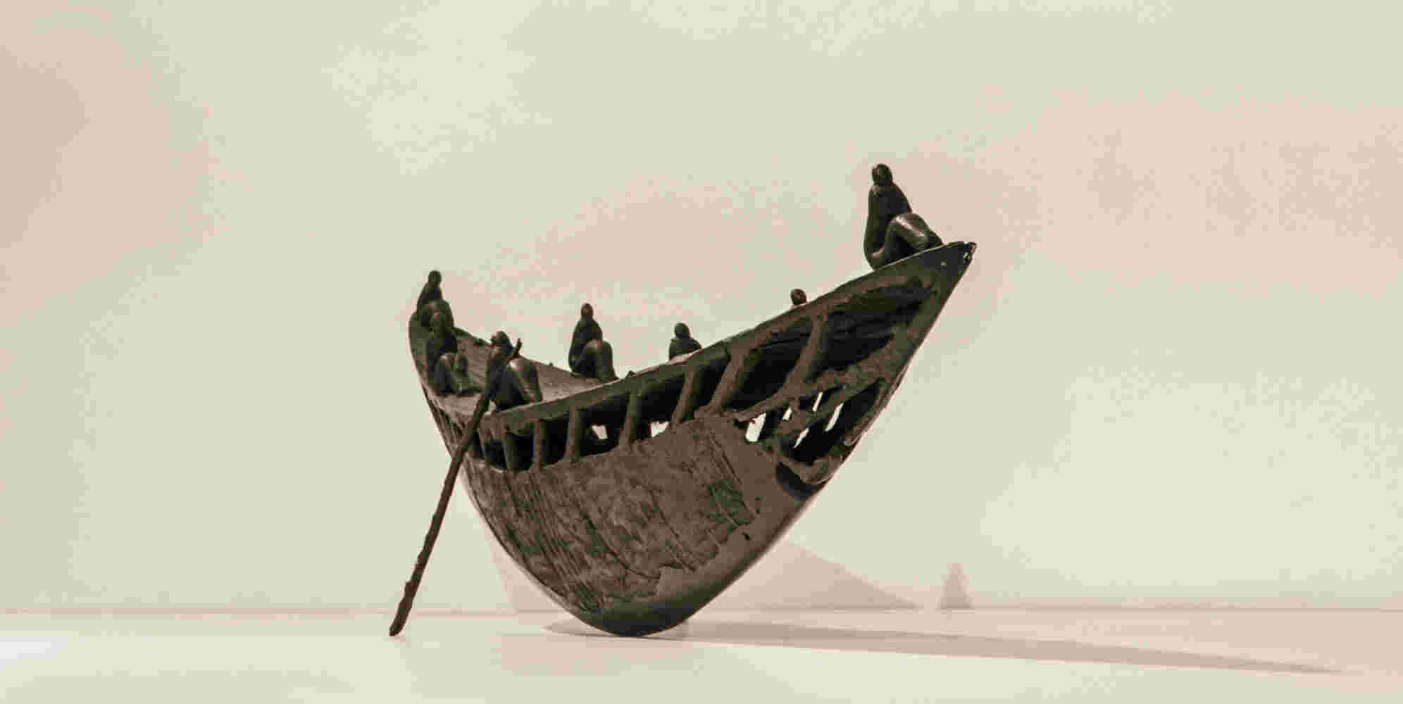 Small boat sculpture made of cast bronze.