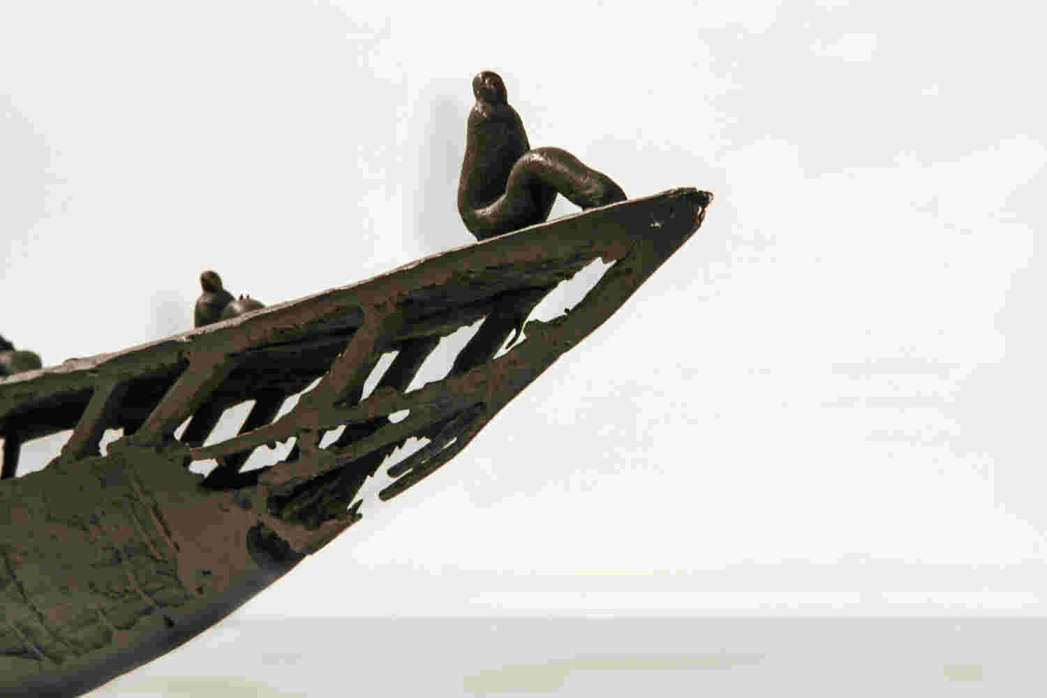 Small boat sculpture made of cast bronze.