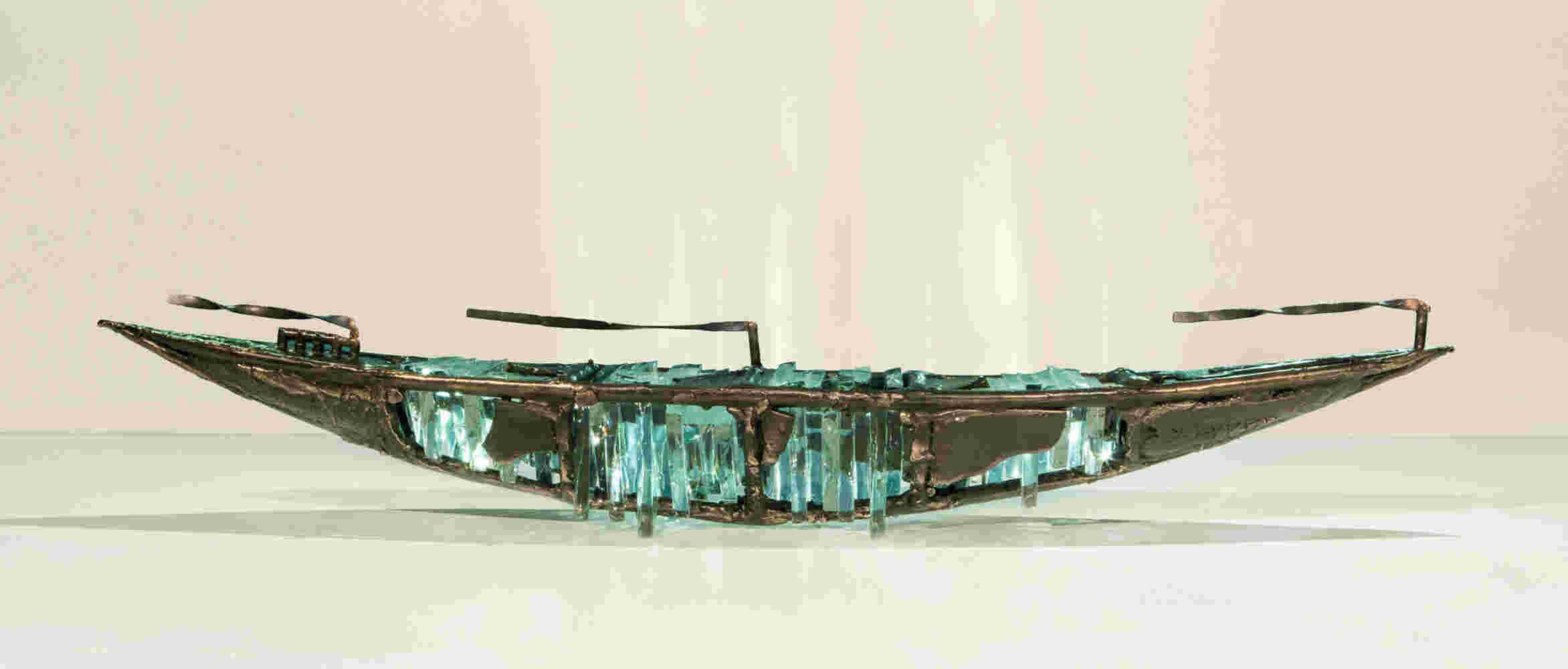 Shipwreck boat sculpture made of hand cut glass and bronze.