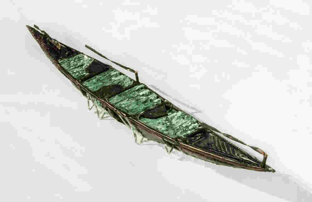 Shipwreck boat sculpture made of hand cut glass and bronze.