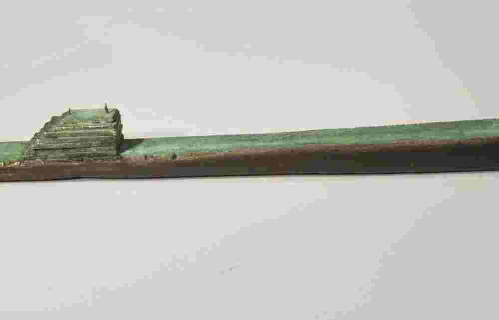 Small boat sculpture made of cast bronze.