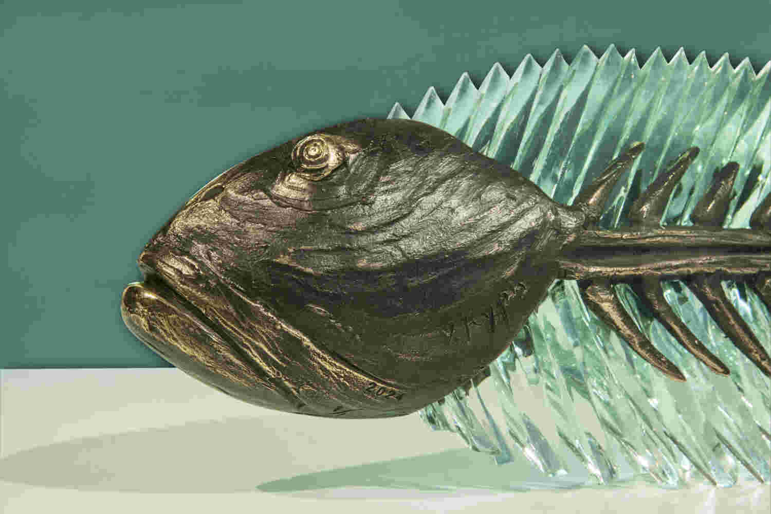 Cast bronze & glass sculpture of a fish. “Frozen Fish”.