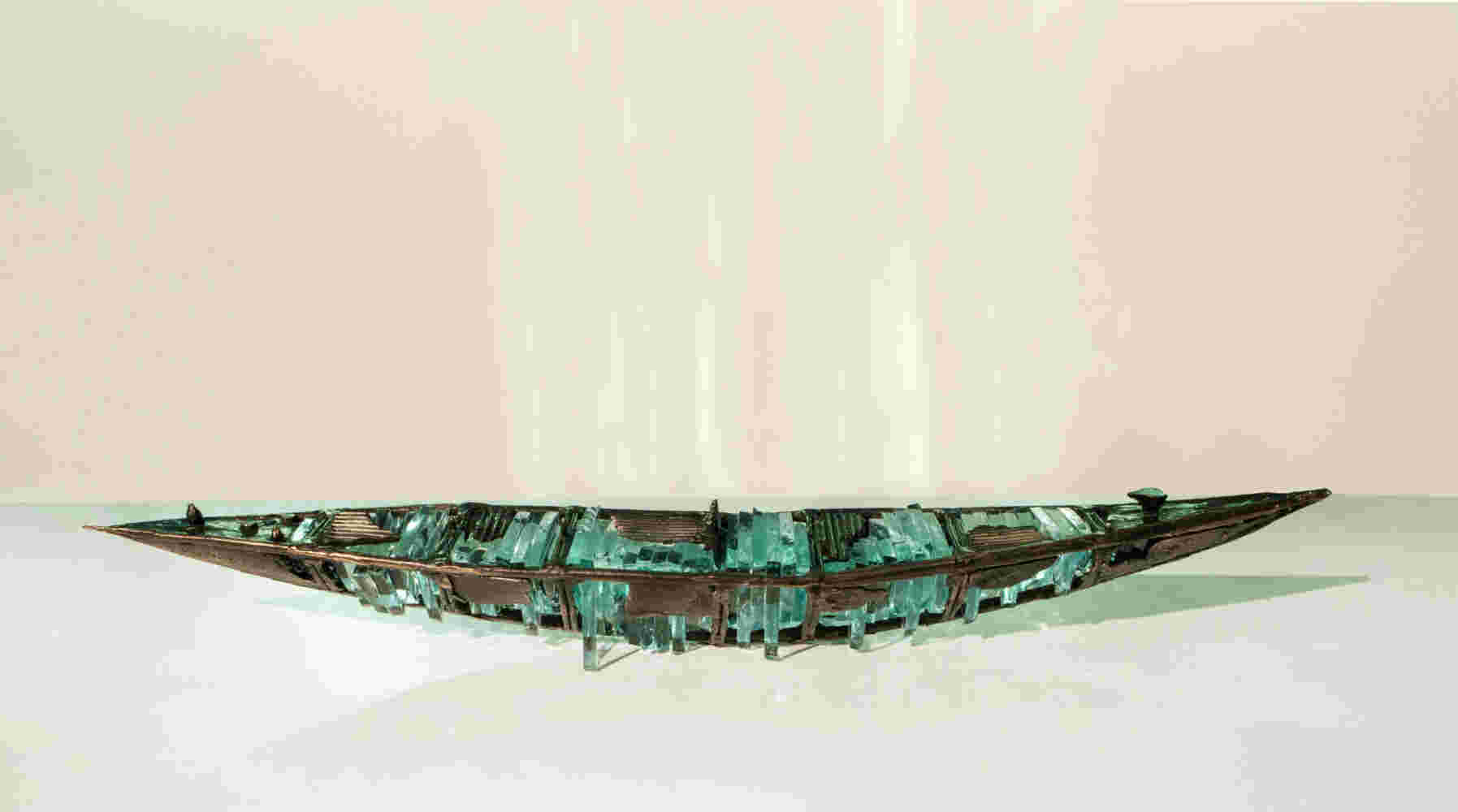 Shipwreck boat sculpture made of hand cut glass and bronze.