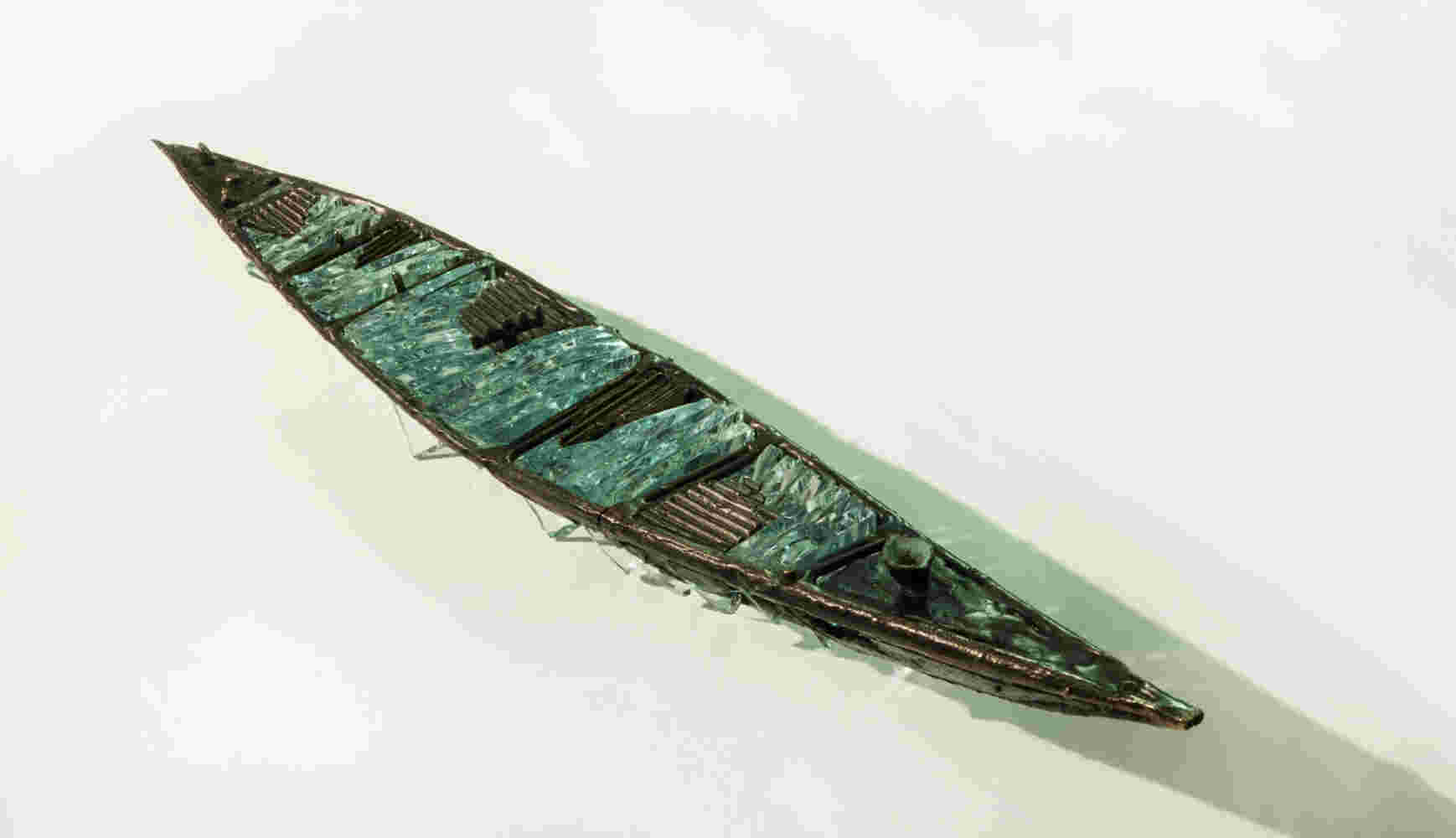 Shipwreck boat sculpture made of hand cut glass and bronze.