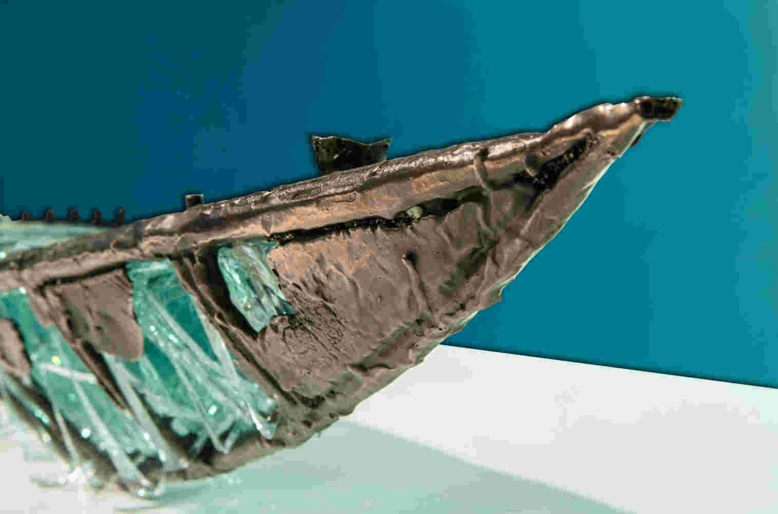 Shipwreck boat sculpture made of hand cut glass and bronze.