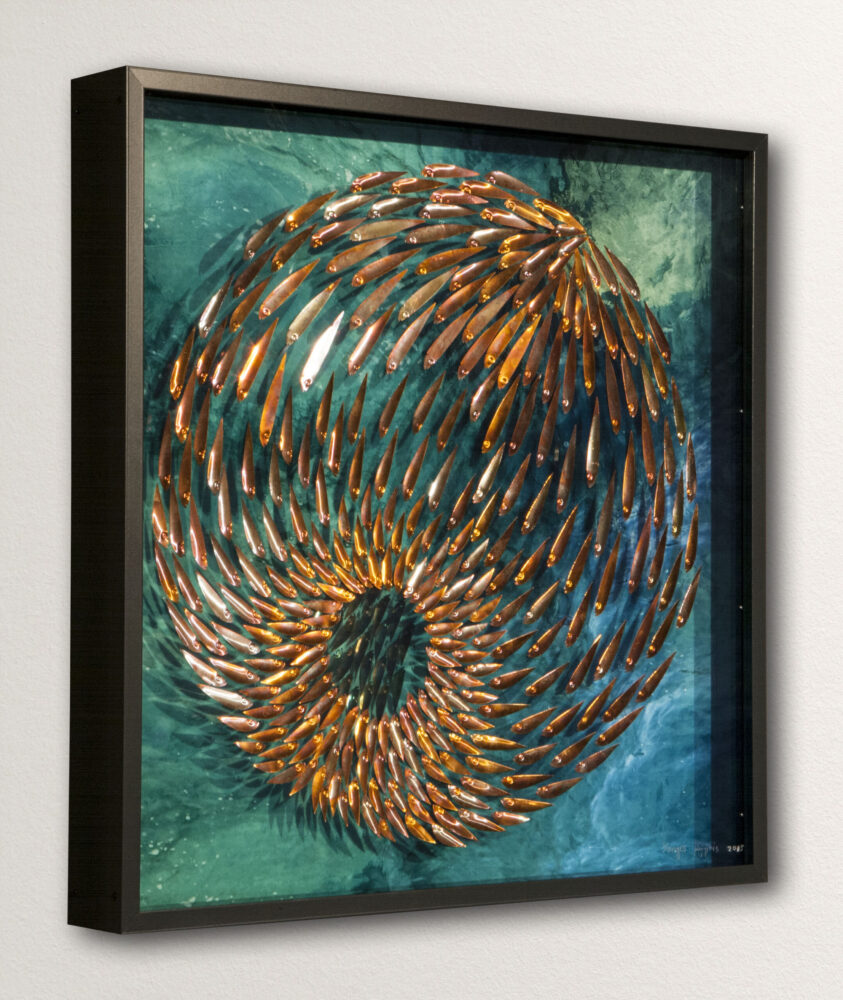 Three-dimensional wall sculpture, school of fish theme, with layers of plexiglass, aluminum frame and spherical aluminum fish.