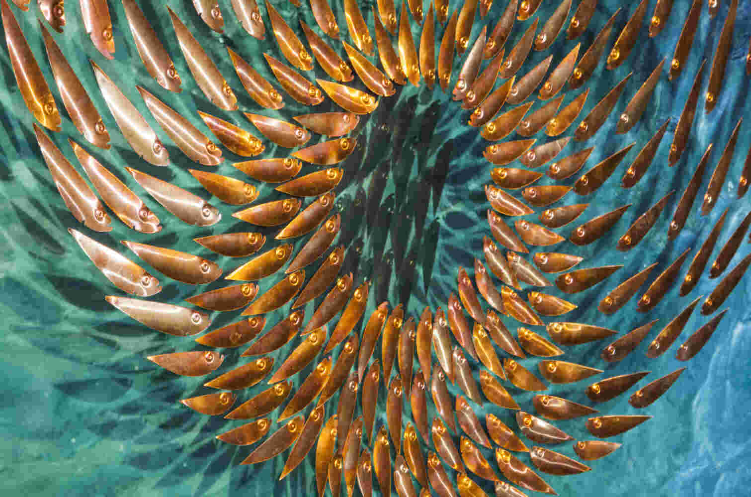 Three-dimensional wall sculpture, school of fish theme, with layers of plexiglass, aluminum frame and spherical aluminum fish.