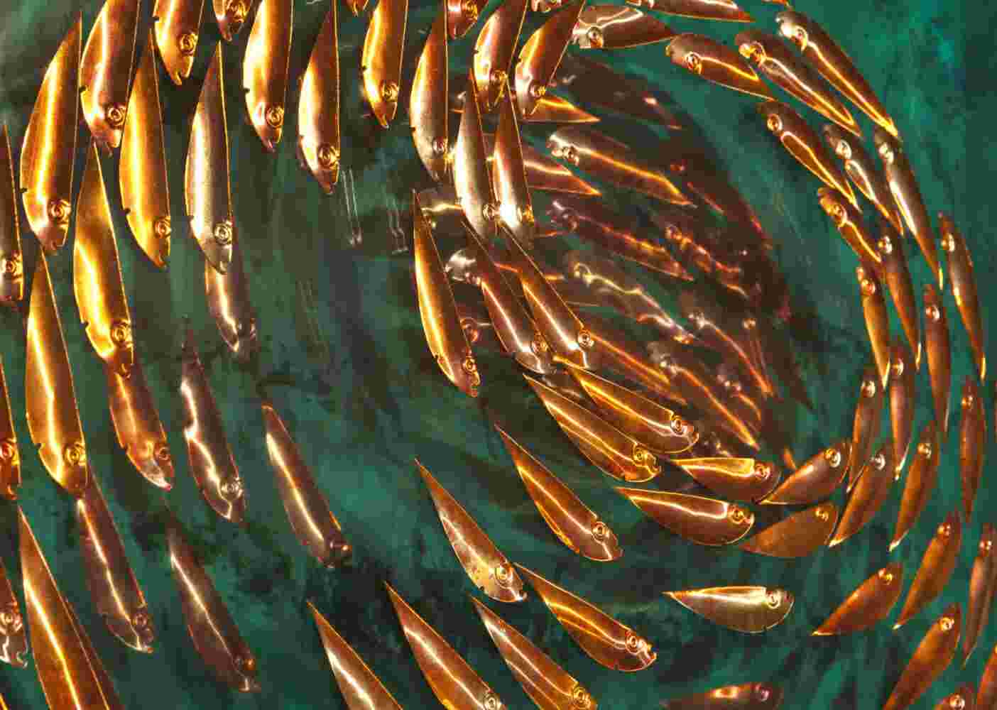Three-dimensional wall sculpture, school of fish theme, with layers of plexiglass, aluminum frame and spherical copper fish.
