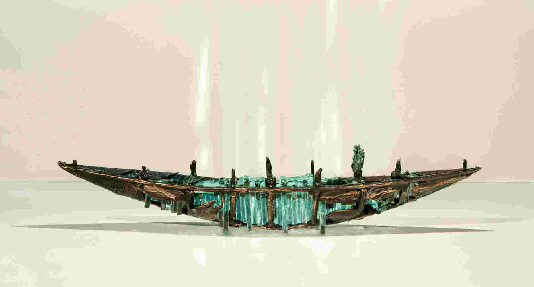 Shipwreck boat sculpture made of hand cut glass and bronze.