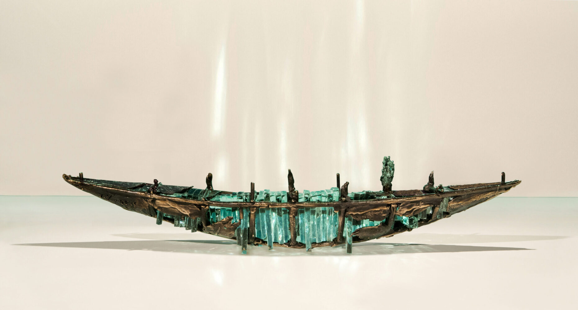 Shipwreck boat sculpture made of hand cut glass and bronze.