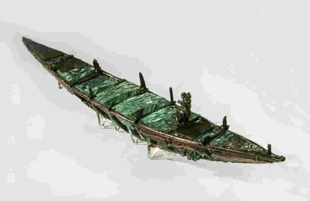 Shipwreck boat sculpture made of hand cut glass and bronze.