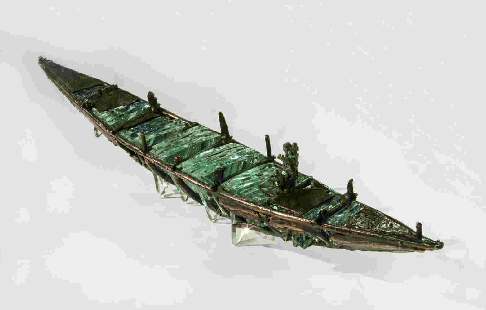 Shipwreck boat sculpture made of hand cut glass and bronze.