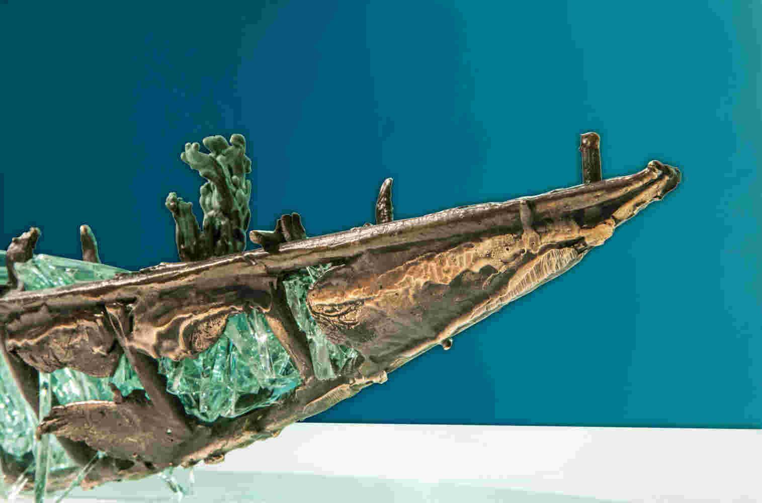 Shipwreck boat sculpture made of hand cut glass and bronze.