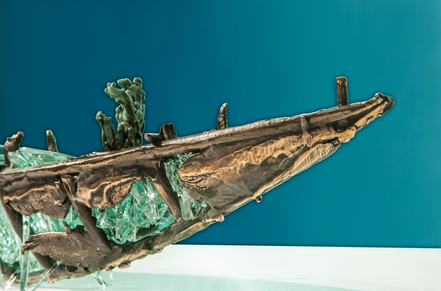 Shipwreck boat sculpture made of hand cut glass and bronze.