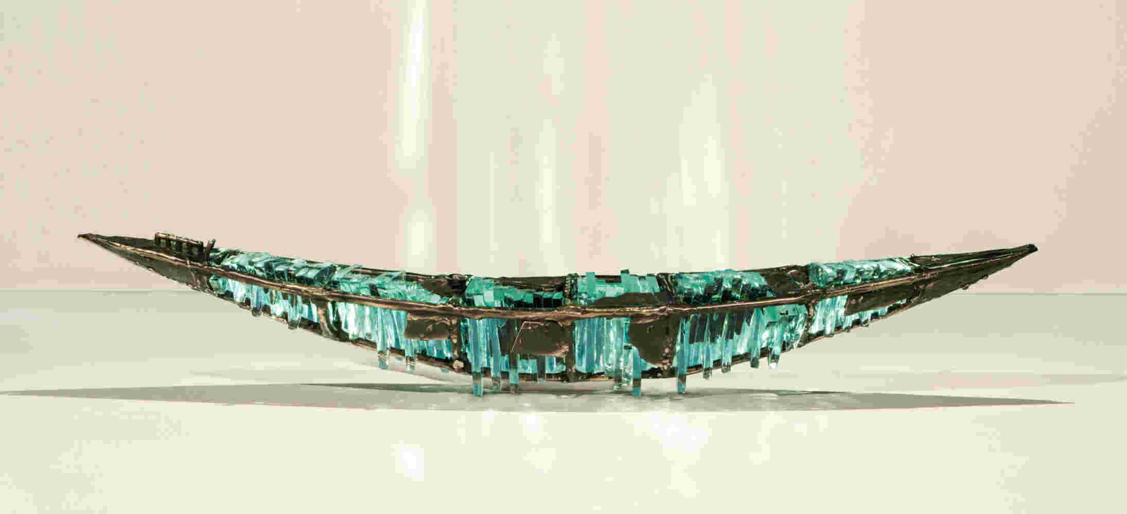 Shipwreck boat sculpture made of hand cut glass and bronze.