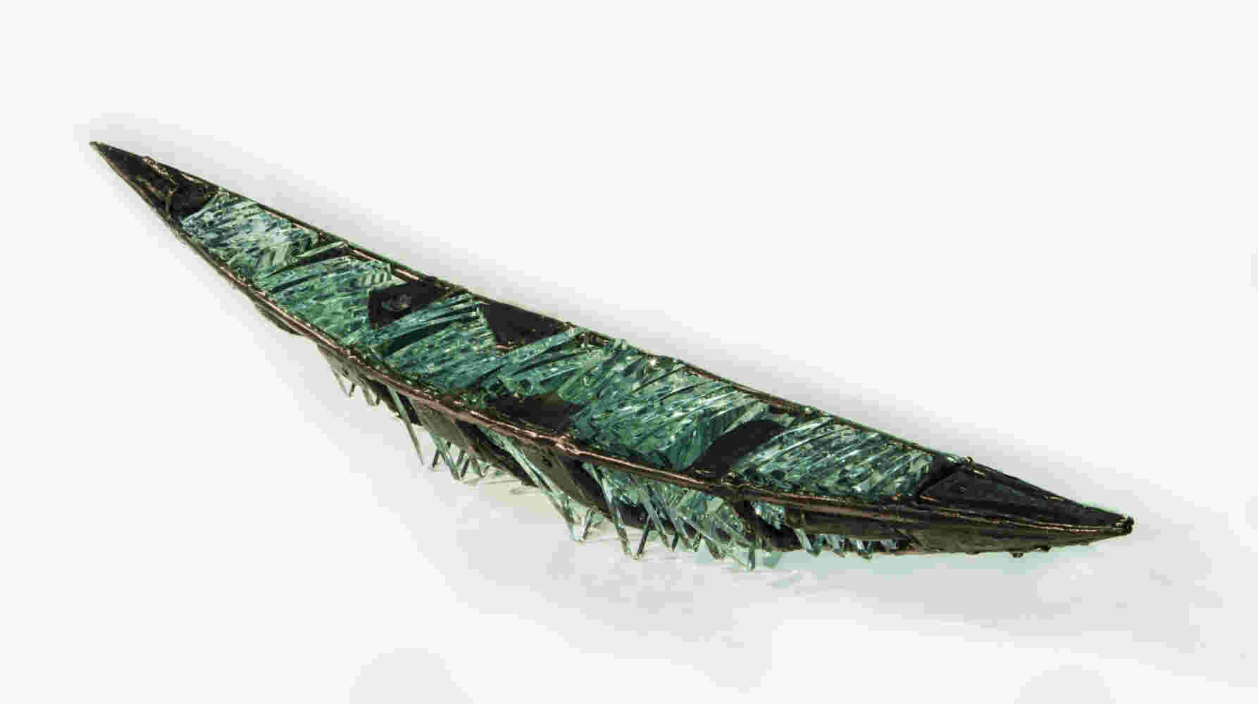 Shipwreck boat sculpture made of hand cut glass and bronze.