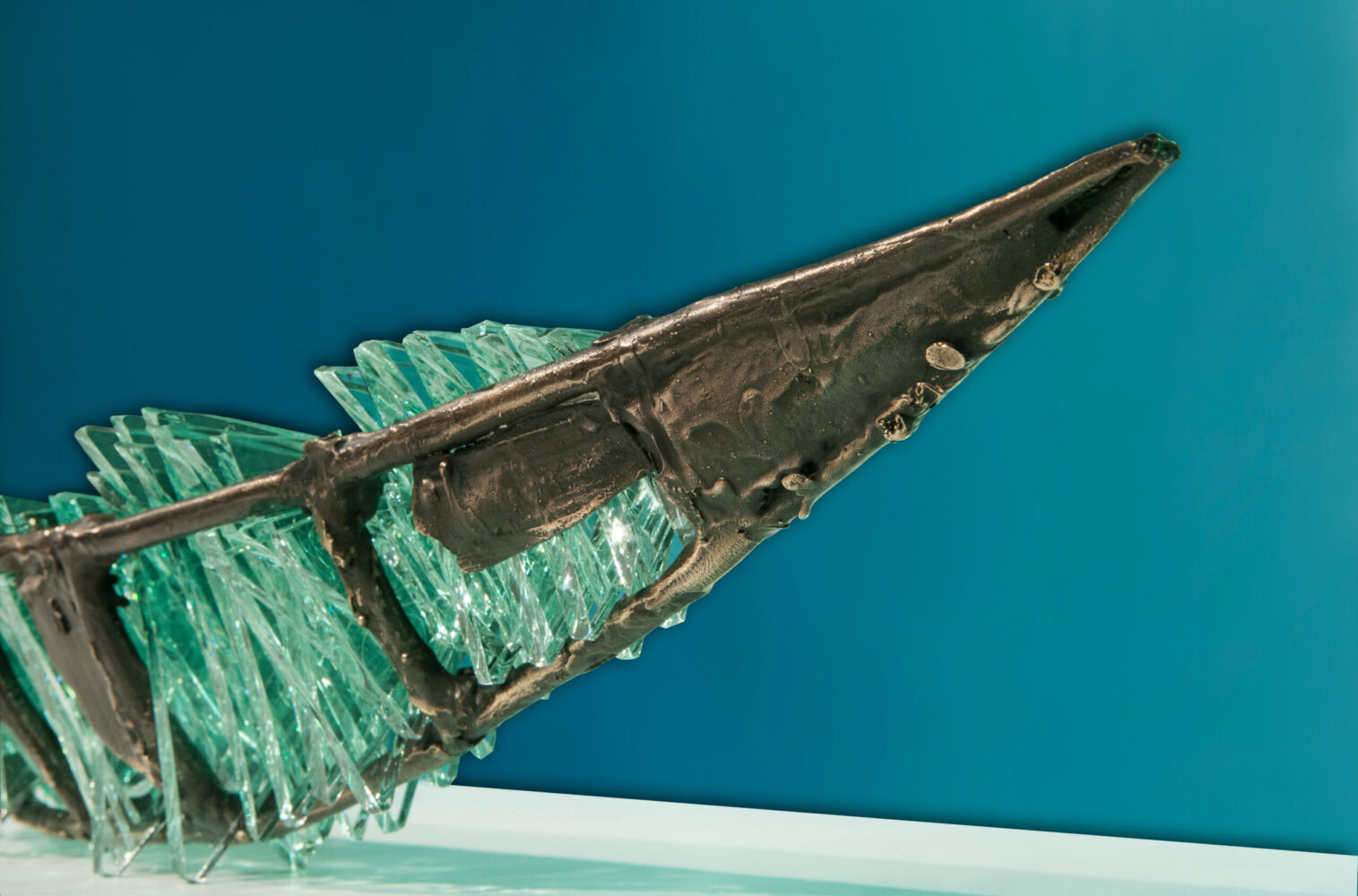Shipwreck boat sculpture made of hand cut glass and bronze.