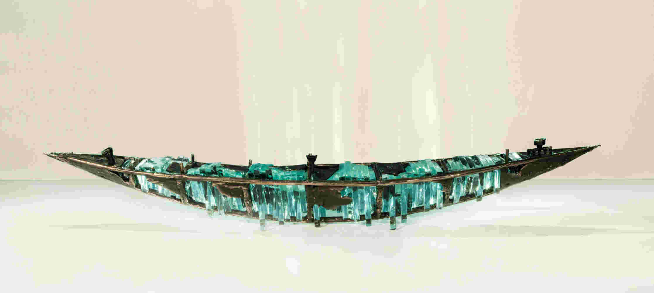 Shipwreck boat sculpture made of hand cut glass and bronze.