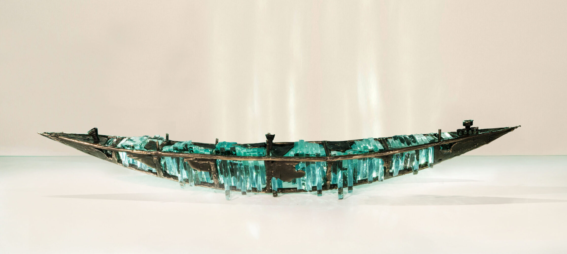Shipwreck boat sculpture made of hand cut glass and bronze.