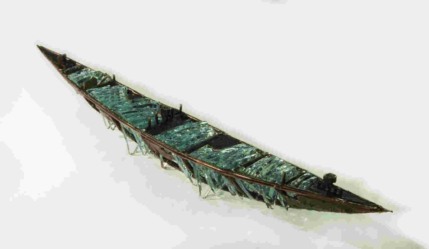 Shipwreck boat sculpture made of hand cut glass and bronze.