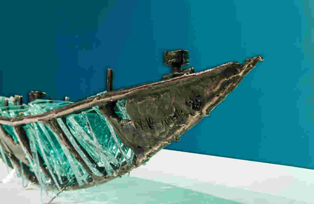 Shipwreck boat sculpture made of hand cut glass and bronze.