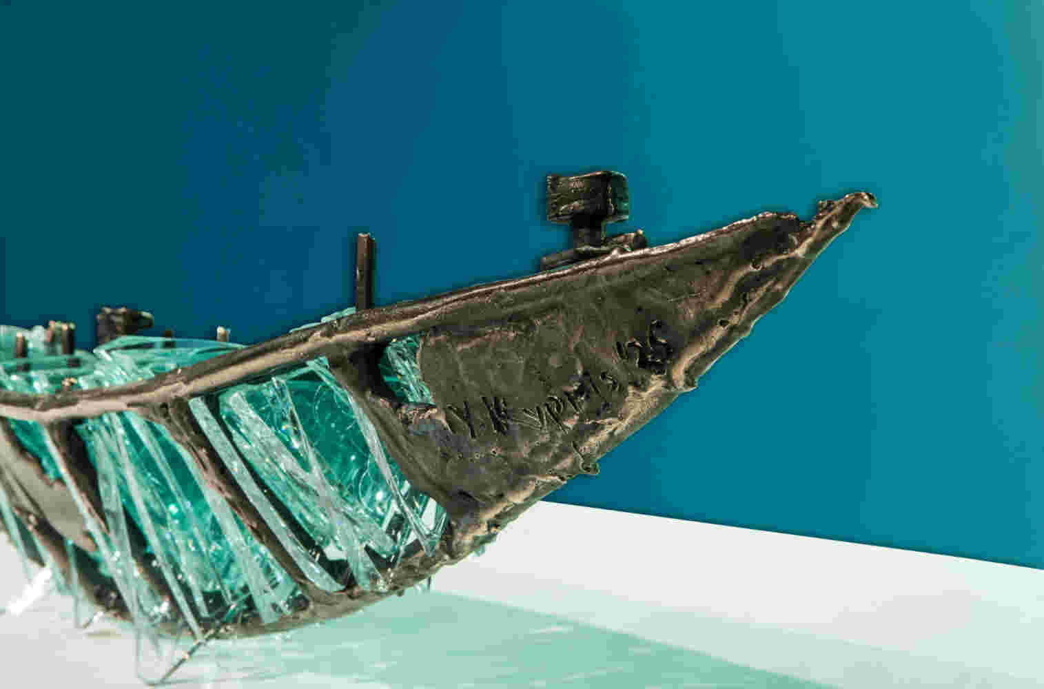 Shipwreck boat sculpture made of hand cut glass and bronze.