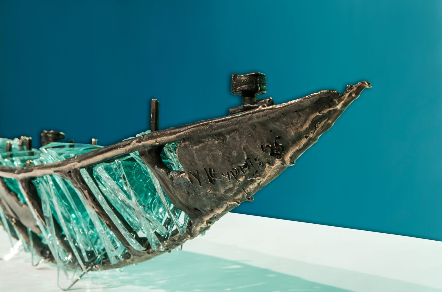 Shipwreck boat sculpture made of hand cut glass and bronze.
