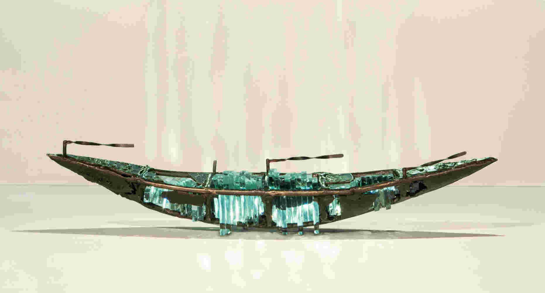 Shipwreck boat sculpture made of hand cut glass and bronze.