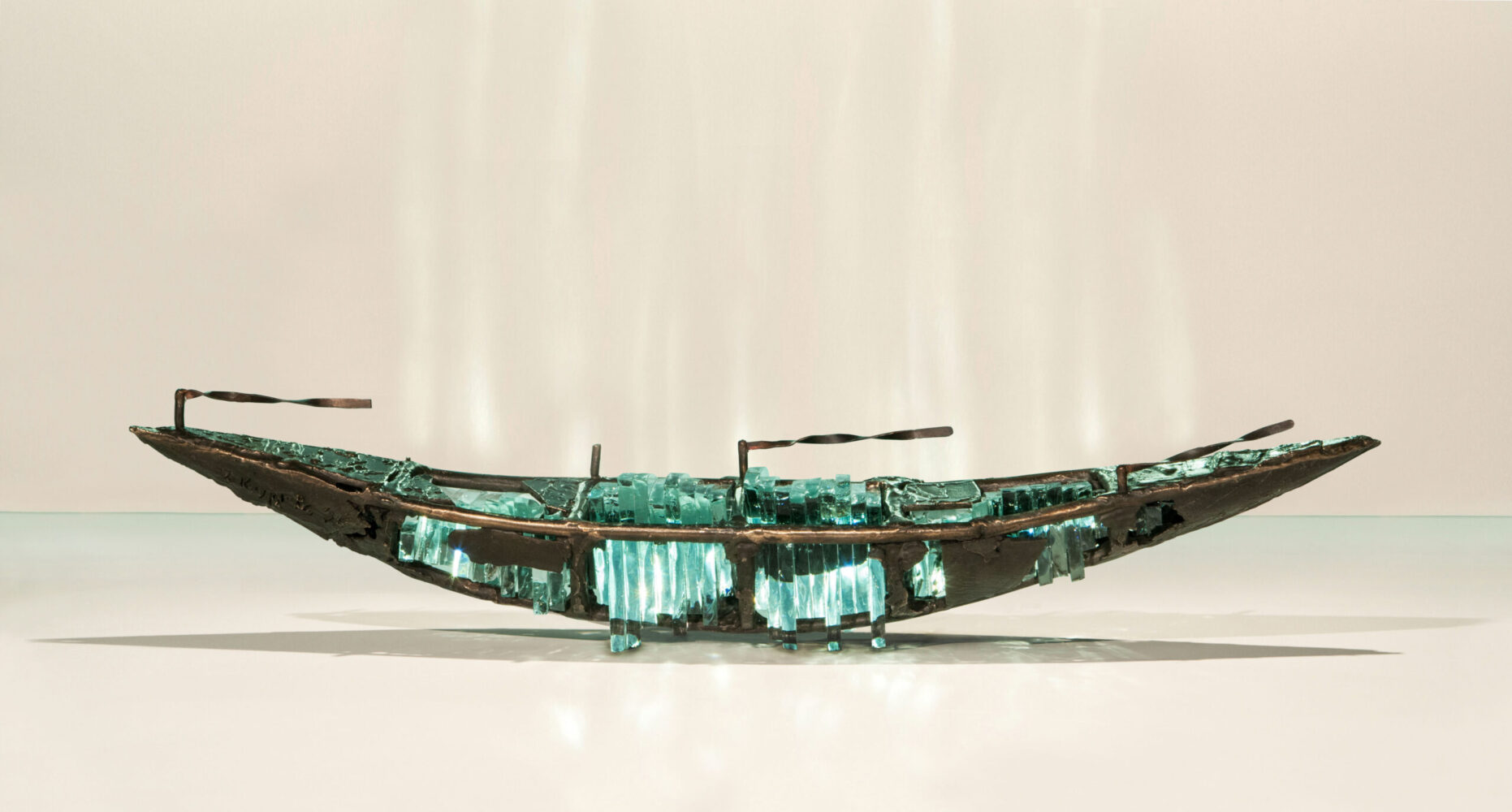 Shipwreck boat sculpture made of hand cut glass and bronze.
