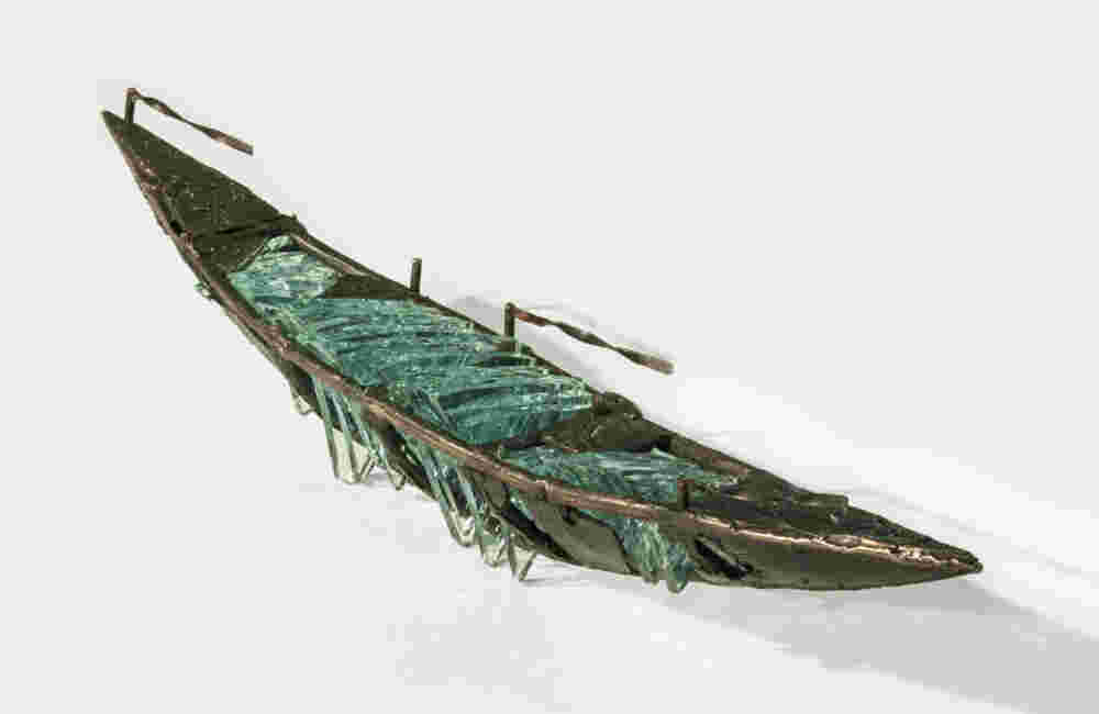 Shipwreck boat sculpture made of hand cut glass and bronze.