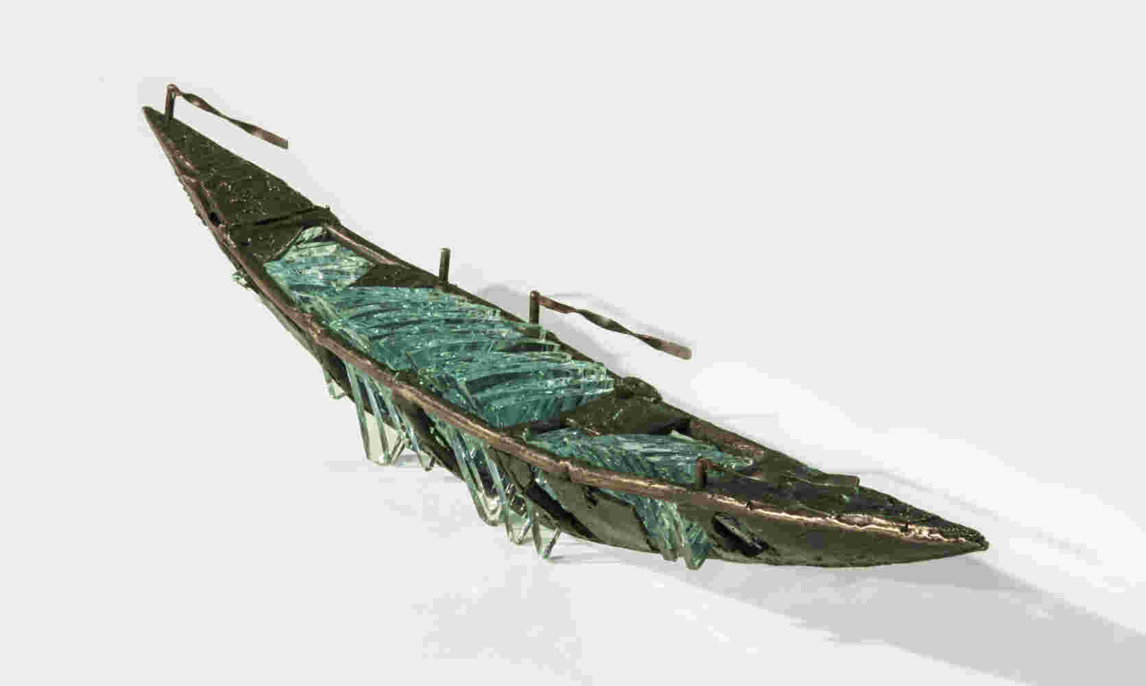 Shipwreck boat sculpture made of hand cut glass and bronze.