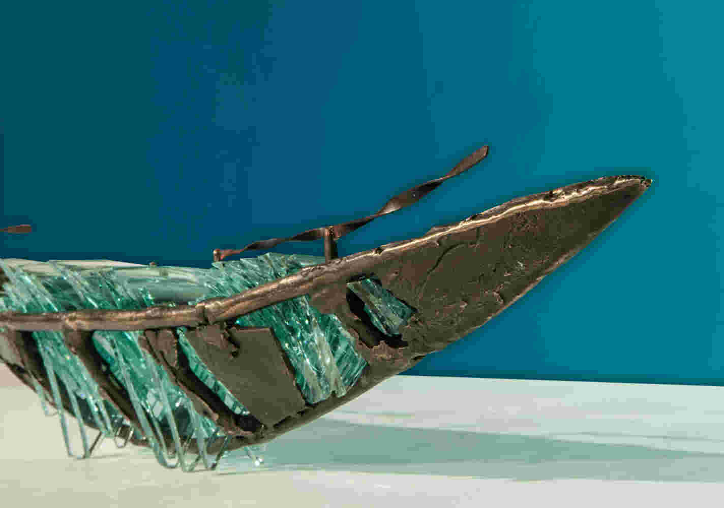 Shipwreck boat sculpture made of hand cut glass and bronze.
