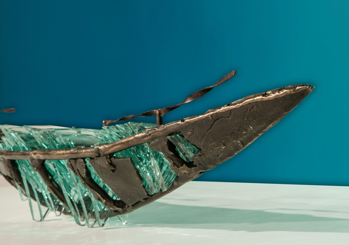 Shipwreck boat sculpture made of hand cut glass and bronze.