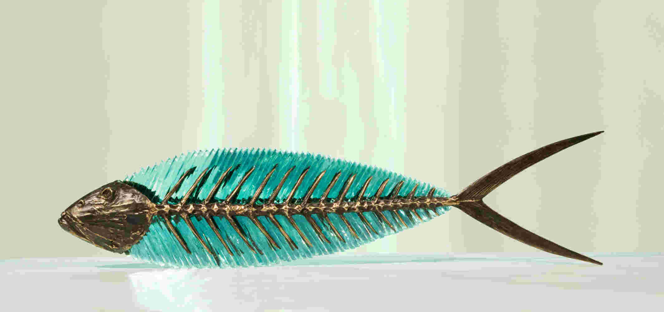 Hand cut glass and bronze sculpture of a fish.
