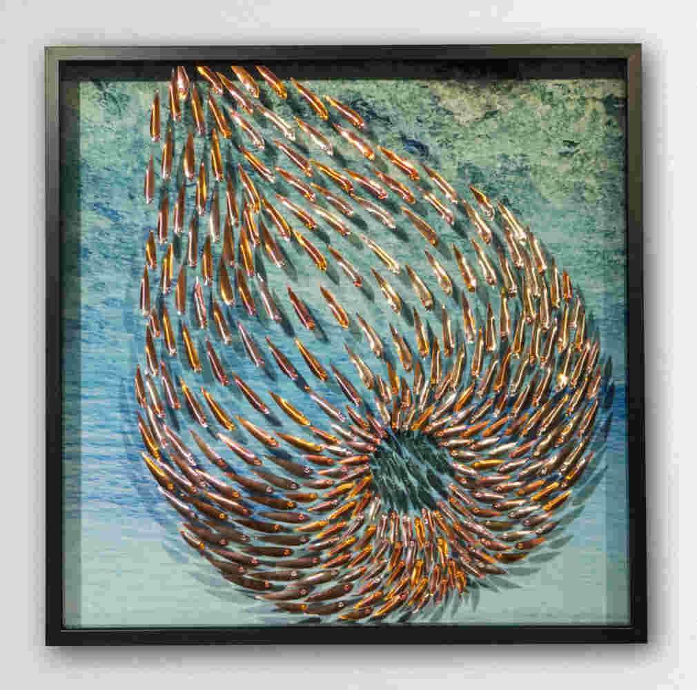 Three-dimensional wall sculpture, school of fish theme, with layers of plexiglass, aluminum frame and swirling copper fish.
