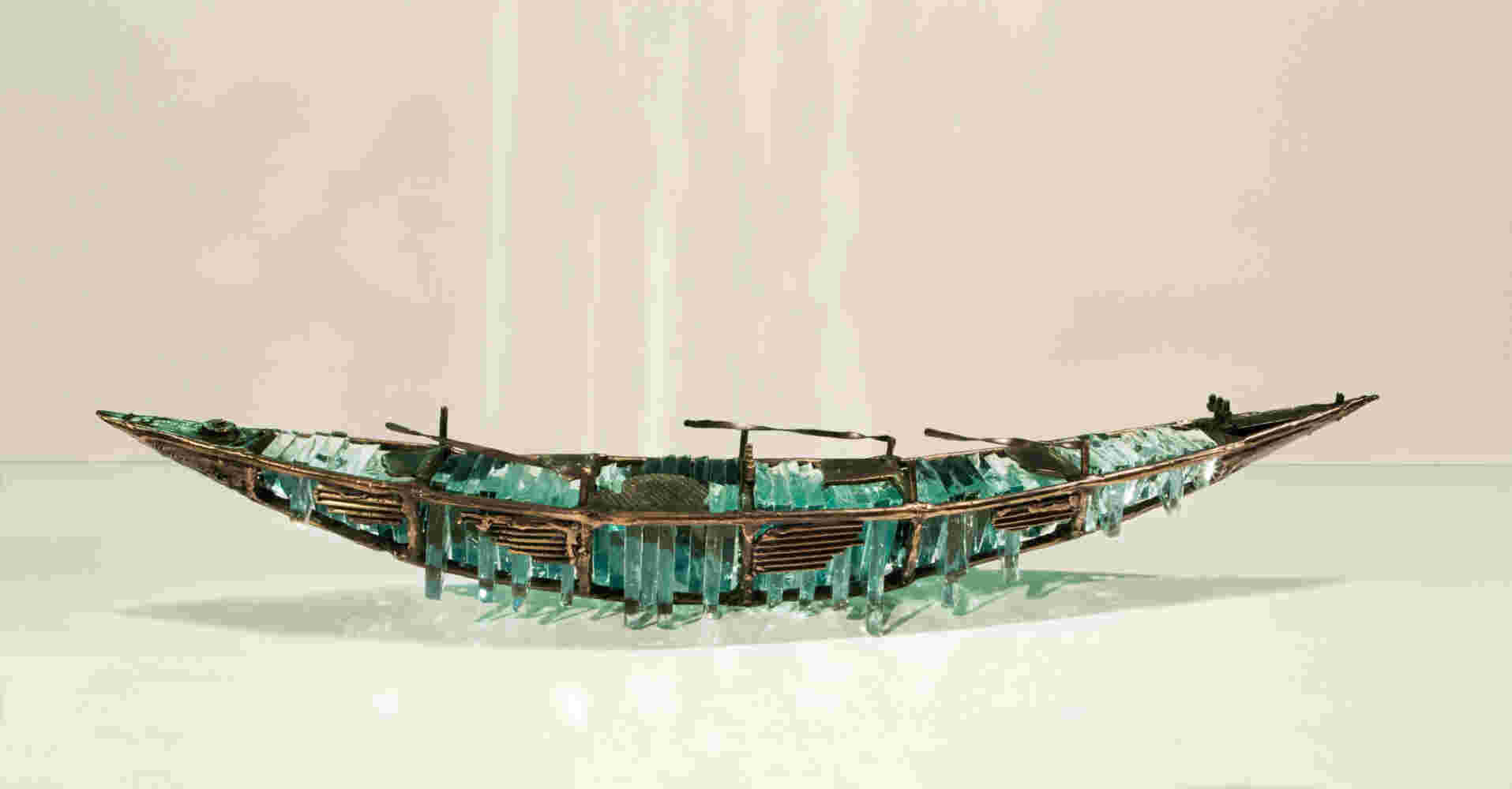 Shipwreck boat sculpture made of hand cut glass and bronze.