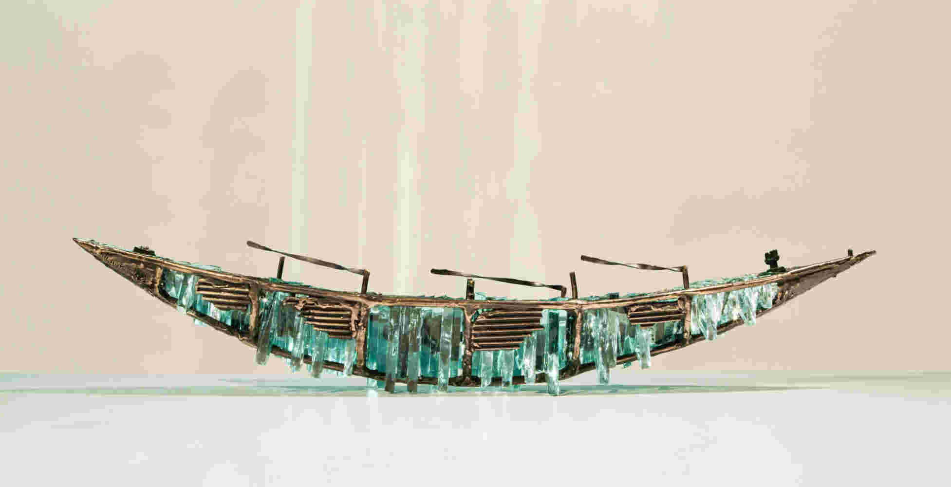 Shipwreck boat sculpture made of hand cut glass and bronze.
