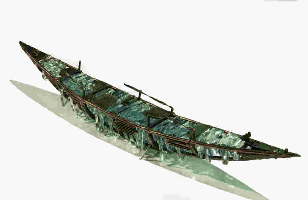 Shipwreck boat sculpture made of hand cut glass and bronze.