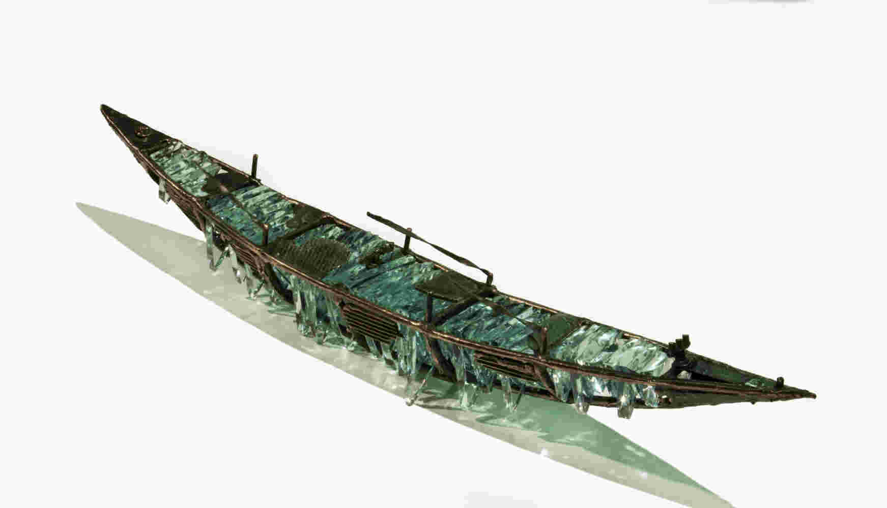 Shipwreck boat sculpture made of hand cut glass and bronze.