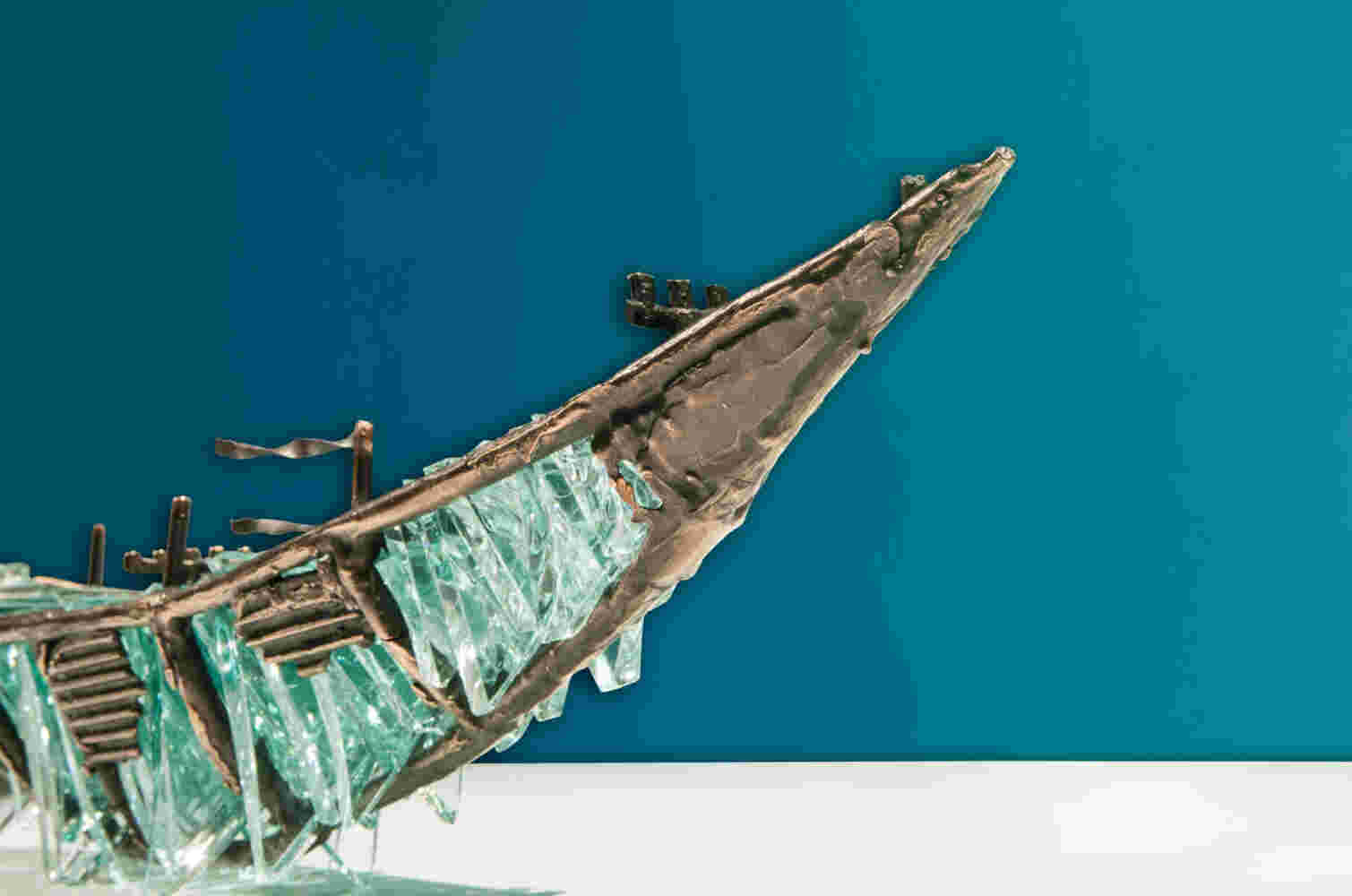 Shipwreck boat sculpture made of hand cut glass and bronze.